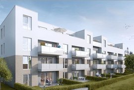 Moderne Wohnanlage mit mehreren Etagen, großen Fenstern und Balkonen, umgeben von gepflegten Grünflächen.